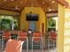 Poolside bar and lounge area with TV and ceiling fans at 5373 Compass Pt # 1, Oxford, FL 34484