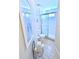 Cozy bathroom featuring a glass-enclosed shower, white toilet, and tasteful coastal decor at 5373 Compass Pt # 1, Oxford, FL 34484