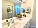 Bathroom with double sinks, vanity, and modern lighting fixtures at 5373 Compass Pt # 1, Oxford, FL 34484