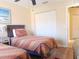 Inviting bedroom with two twin beds featuring striped bedding and a spacious closet at 5373 Compass Pt # 1, Oxford, FL 34484