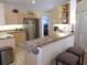 Kitchen boasts a breakfast bar, ample counter space, and stainless steel appliances at 5373 Compass Pt # 1, Oxford, FL 34484