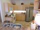 Bright kitchen featuring stainless steel appliances, ample cabinets, and eat-in bar at 5373 Compass Pt # 1, Oxford, FL 34484