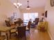 Bright living room featuring hardwood floors, ceiling fans, and sliding glass doors at 5373 Compass Pt # 1, Oxford, FL 34484