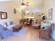 Cozy living room featuring hardwood floors, ceiling fans, and comfortable seating at 5373 Compass Pt # 1, Oxford, FL 34484