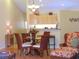 Open-concept living space features a cozy dining area and modern lighting at 5373 Compass Pt # 1, Oxford, FL 34484