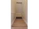 Wooden staircase leading to a lower level with tile flooring, and door access at 5373 Compass Pt # 1, Oxford, FL 34484