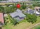Overhead view of the property in a lush neighborhood with a screened-in pool and proximity to the lake at 5530 Oxford Moor Blvd, Windermere, FL 34786