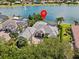 An aerial view highlighting a stunning home with a pool and waterfront access on a serene lake at 5530 Oxford Moor Blvd, Windermere, FL 34786