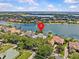 Beautiful lakeside property featuring lush landscaping, a fountain, and stunning water views in a desirable neighborhood at 5530 Oxford Moor Blvd, Windermere, FL 34786
