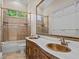 Traditional bathroom boasts a double vanity with marble countertops, tiled shower, and a large mirror at 5530 Oxford Moor Blvd, Windermere, FL 34786