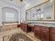 Bright bathroom with double vanity, soaking tub, decorative rug, and tile floor at 5530 Oxford Moor Blvd, Windermere, FL 34786