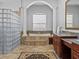 Spa-like bathroom features a soaking tub, glass block wall, and double vanity at 5530 Oxford Moor Blvd, Windermere, FL 34786