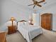This serene bedroom boasts a white comforter, ceiling fan, and antique wood furniture at 5530 Oxford Moor Blvd, Windermere, FL 34786