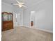 Spacious bedroom with neutral walls, carpet, vintage wood dresser, and multiple doorways at 5530 Oxford Moor Blvd, Windermere, FL 34786