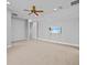 A spacious bedroom offers a ceiling fan, a wall-mounted TV, and recessed lighting at 5530 Oxford Moor Blvd, Windermere, FL 34786