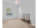 Clean, minimalist bedroom featuring neutral walls, carpet, window, and a pair of matching chairs at 5530 Oxford Moor Blvd, Windermere, FL 34786