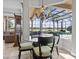 Bright breakfast nook featuring a glass table, a chandelier, and views of the pool and lake at 5530 Oxford Moor Blvd, Windermere, FL 34786