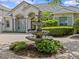 Elegant home with meticulously maintained landscaping and a charming fountain adding curb appeal to the beautiful property at 5530 Oxford Moor Blvd, Windermere, FL 34786