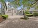 Expansive home with an eye-catching circular driveway, enhanced by a charming water fountain feature at its center at 5530 Oxford Moor Blvd, Windermere, FL 34786