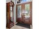 A classic grandfather clock stands near the front door with decorative glass, showcasing a traditionally styled foyer at 5530 Oxford Moor Blvd, Windermere, FL 34786