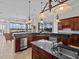 Gourmet kitchen with stainless steel appliances and granite countertops overlooking the water at 5530 Oxford Moor Blvd, Windermere, FL 34786