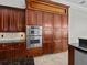 Gourmet kitchen with stainless steel appliances and custom wood cabinetry at 5530 Oxford Moor Blvd, Windermere, FL 34786