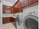 Laundry room boasts generous cabinet space, counter, and modern appliances at 5530 Oxford Moor Blvd, Windermere, FL 34786