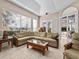 Open living room with large windows, tile floors, and comfortable seating at 5530 Oxford Moor Blvd, Windermere, FL 34786