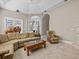 Open living room with large windows, tile floors, comfortable seating, and an elephant statue at 5530 Oxford Moor Blvd, Windermere, FL 34786
