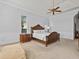 Elegant main bedroom with a luxurious bed, classic decor, and abundant natural light at 5530 Oxford Moor Blvd, Windermere, FL 34786