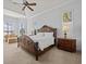 Spacious main bedroom boasts a large bed, sitting area, and views from multiple windows at 5530 Oxford Moor Blvd, Windermere, FL 34786