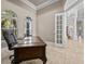 Bright office with a large desk, comfortable chair, and an open doorway at 5530 Oxford Moor Blvd, Windermere, FL 34786