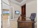 Home office with built-in bookcase, a large desk, and views of the pool area at 5530 Oxford Moor Blvd, Windermere, FL 34786
