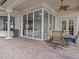 Outdoor patio with a dining set, offering a cozy space for meals and relaxation, with views into the living area at 5530 Oxford Moor Blvd, Windermere, FL 34786