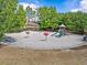 Community playground surrounded by lush greenery, providing a safe and fun recreational space for children at 5530 Oxford Moor Blvd, Windermere, FL 34786