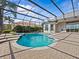 Beautiful screened-in pool with a connecting spa and brick pavers, perfect for enjoying the outdoors in privacy at 5530 Oxford Moor Blvd, Windermere, FL 34786