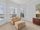 Cozy sitting area in the main bedroom features comfortable chair and ottoman, with a view at 5530 Oxford Moor Blvd, Windermere, FL 34786