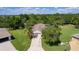 Aerial view of a home showcasing lush landscaping, a long driveway and a well-manicured lawn in a peaceful neighborhood at 5941 Sage Leaf Pl, Leesburg, FL 34748