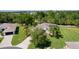 Aerial view of a beautiful home showing lush greenery, a well-manicured lawn, and a private driveway at 5941 Sage Leaf Pl, Leesburg, FL 34748