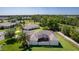 Aerial view of a residential home showcasing a screened-in patio, surrounded by lush greenery and well-kept lawns at 5941 Sage Leaf Pl, Leesburg, FL 34748