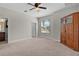 Spacious bedroom with large window for natural light and convenient access to the bathroom at 5941 Sage Leaf Pl, Leesburg, FL 34748
