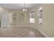 Bright dining room with neutral walls, tile floors, and natural light from two large windows at 5941 Sage Leaf Pl, Leesburg, FL 34748