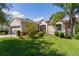 Inviting single-story home with a well-manicured lawn and mature landscaping adding to its curb appeal at 5941 Sage Leaf Pl, Leesburg, FL 34748