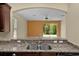 Kitchen sink featuring granite countertops and stainless steel appliances at 5941 Sage Leaf Pl, Leesburg, FL 34748