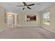 Comfortable living room with a view to the kitchen, plus neutral paint and trim throughout at 5941 Sage Leaf Pl, Leesburg, FL 34748