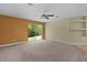 Bright living room featuring neutral walls, and sliding glass doors offering indoor-outdoor living at 5941 Sage Leaf Pl, Leesburg, FL 34748