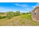 Expansive backyard with lush greenery and landscaping at 597 Skyridge Rd, Clermont, FL 34711