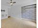 Spacious bedroom with carpeted floors, built-in shelving, and a closet with gray tile at 597 Skyridge Rd, Clermont, FL 34711