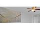 Bedroom featuring a ceiling fan, neutral walls, and an architectural accent painting at 597 Skyridge Rd, Clermont, FL 34711