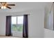 This bedroom features neutral walls, window with curtains, and ample natural light at 597 Skyridge Rd, Clermont, FL 34711